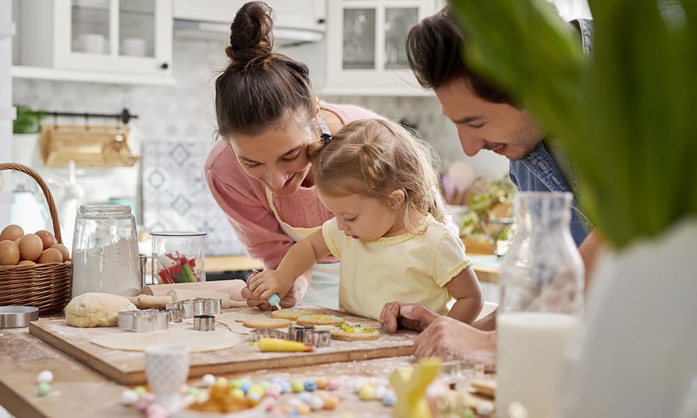 Blog - Family Making Cookies in Kitchen and Decorating for Easter